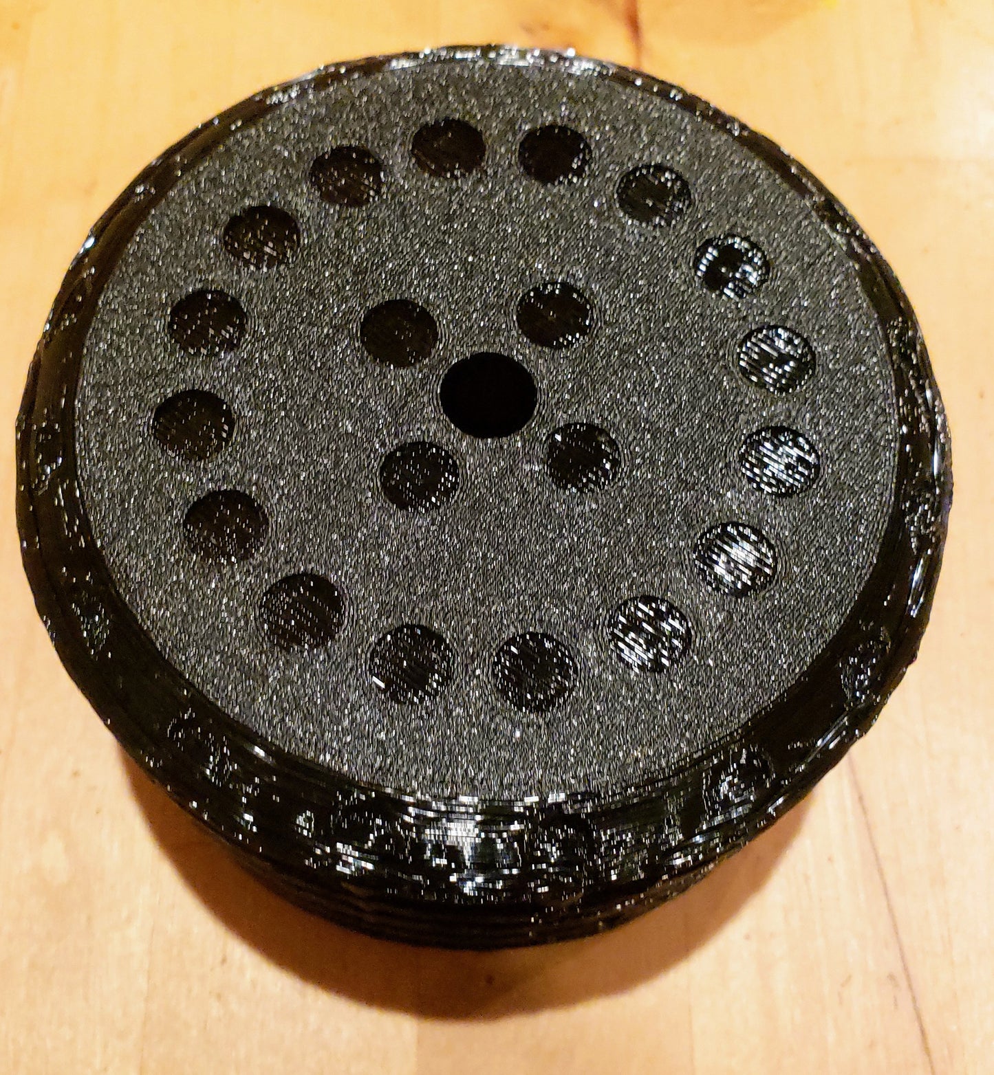 Back side of the Paintball Tank Cover Tube butt. Shows grit and 3d print texture and little circles.